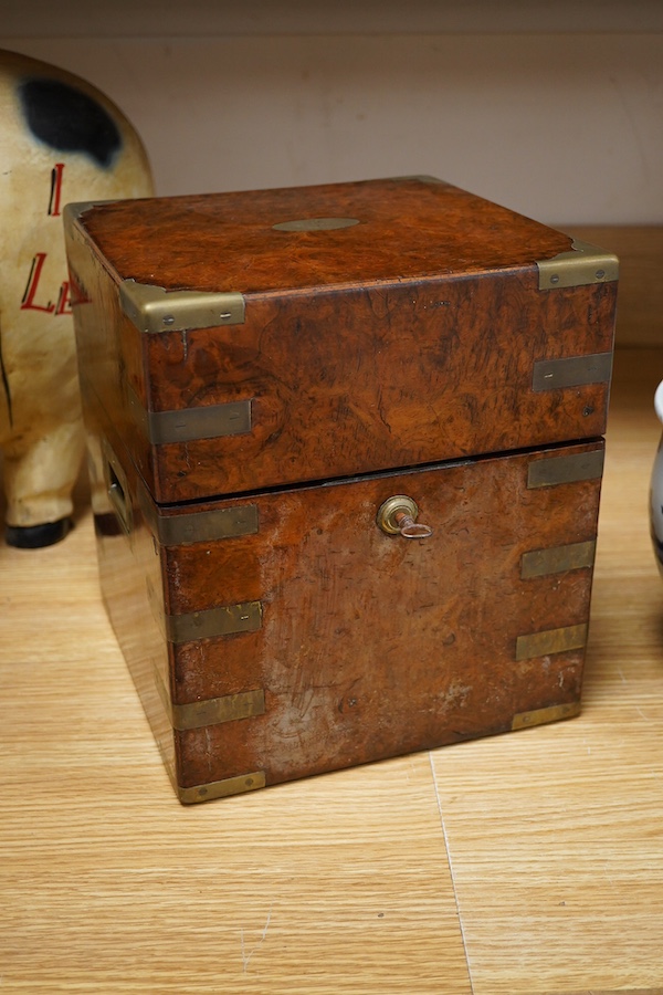 A Victorian burr walnut and brass bound four bottle decanter box, the four faceted square decanters with Victorian silver spirit labels, Bramah lock with key, 26cm high